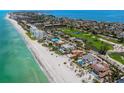 Aerial view of beachfront homes including manicured lawns, in a coastal community with beach access and ocean views at 845 Longboat Club Rd, Longboat Key, FL 34228