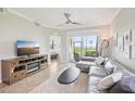 Inviting living room boasting neutral tones, a modern ceiling fan, and scenic views at 850 Tidewater Shores Loop # 108, Bradenton, FL 34208