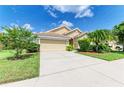 Well-maintained home with a two-car garage, neutral paint, and tropical landscaping at 8772 Stone Harbour Loop, Bradenton, FL 34212