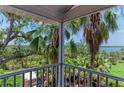 Balcony view overlooking lush tropical foliage and tranquil waterway at 8963 Fishermens Bay Dr, Sarasota, FL 34231