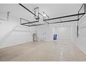 Spacious garage with storage shelves and epoxy flooring at 926 Fernleaf Run, Bradenton, FL 34212
