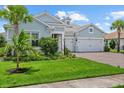 Inviting home with a well-maintained lawn, brick driveway, and a two-car garage at 12139 Cranston Way, Bradenton, FL 34211
