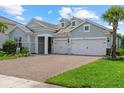 Beautiful single-Gathering home featuring a brick driveway and a two-car garage at 12139 Cranston Way, Bradenton, FL 34211