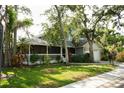Charming two-story home featuring a screened porch and attached two-car garage surrounded by lush greenery at 1505 43Rd Avenue W Dr, Palmetto, FL 34221
