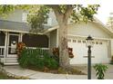 Well-maintained home showcasing a two-car garage, charming front porch and attractive landscaping at 1505 43Rd Avenue W Dr, Palmetto, FL 34221