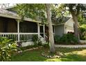 Inviting front porch and meticulously landscaped yard surrounded by beautiful Florida landscaping at 1505 43Rd Avenue W Dr, Palmetto, FL 34221