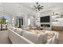 Bright, open living room with fireplace, modern fan, and stylish decor is ideal for entertaining and relaxing at 1605 Landfall Dr, Nokomis, FL 34275