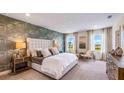 Spacious main bedroom featuring a decorative accent wall, lots of natural light, and neutral decor at 17904 Tavernside Trl, Bradenton, FL 34211