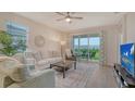 Bright living room with comfortable seating, stylish decor, and a sliding glass door to the outside at 18324 Cropside Trl, Lakewood Ranch, FL 34211