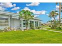 Bright sunroom with large windows and manicured lawn at 202 Bedford Trl # 120, Sun City Center, FL 33573