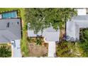 An aerial view of a well-maintained home, showcasing its backyard, landscaping, and the surrounding residential neighborhood at 2204 67Th W St, Bradenton, FL 34209
