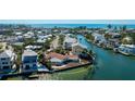 Beautiful waterfront property with dock and lush landscaping on canal at 236 S Harbor Dr, Holmes Beach, FL 34217