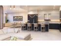 Bright, open kitchen with modern barstool seating, sleek countertops, and contemporary lighting at 290 Cocoanut Ave # 8B, Sarasota, FL 34236