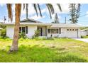 Charming single-story home featuring a lush front yard and an attached one car garage at 3303 Cambridge W Dr, Bradenton, FL 34205