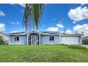 Charming single-story home with a well-maintained lawn, screened-in front porch, and solar panels at 3339 Duar Ter, North Port, FL 34291