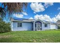 Charming single-story home with a well-maintained lawn, screened-in front porch, and solar panels at 3339 Duar Ter, North Port, FL 34291