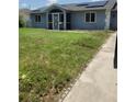 Charming single-story home with a screened front porch and well-maintained lawn at 3339 Duar Ter, North Port, FL 34291