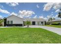 A beautiful home with lush green grass, landscaping and a paved driveway at 3634 Torrey Pines Way Way, Sarasota, FL 34238