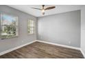 Bright bedroom featuring two windows, wood-look flooring, and modern ceiling fan at 4360 85Th Avenue E Cir, Parrish, FL 34219