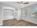 Airy living room featuring wood-look floors, natural light, and a ceiling fan at 4360 85Th Avenue E Cir, Parrish, FL 34219