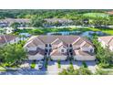 Beautiful aerial view of the townhouse community with lake views, golf course, and lush green landscaping at 4487 Cinnamon Dr # 2604, Sarasota, FL 34238