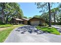 Charming single-story home with attached garage and a long driveway, surrounded by lush greenery at 4555 Chandlers Forde # 47, Sarasota, FL 34235