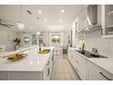 Bright, modern kitchen with island, white cabinets, pendant lights and open floor plan at 460 Daylily Blvd, Nokomis, FL 34275