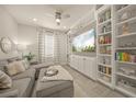 Cozy living room with built-in shelves, plush seating, and neutral décor at 460 Daylily Blvd, Nokomis, FL 34275