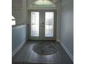 Charming entryway featuring decorative glass double doors, stylish rug, and light gray walls at 5207 86Th Street W Ct, Bradenton, FL 34210