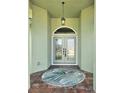 Inviting front entry with double doors, transom window, and decorative hanging light fixture at 5207 86Th Street W Ct, Bradenton, FL 34210