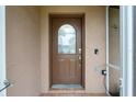 A close-up of a front door with an oval window, showcasing the entry of the home at 5433 81St Avenue E Cir, Palmetto, FL 34221