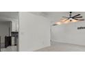 Minimalist living room featuring tile flooring and a view of the kitchen area at 5433 81St Avenue E Cir, Palmetto, FL 34221
