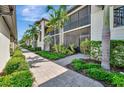 Attractive condo exterior with lush tropical landscaping, and inviting pathway at 5695 Palmer Cir # 203, Bradenton, FL 34211