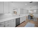 Open-concept kitchen with white cabinetry, stainless steel appliances, and views into the dining area at 5866 Cavano Dr, Sarasota, FL 34231