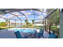 Enclosed pool area with a lake view, showcasing outdoor seating and a serene backyard oasis at 6107 French Creek Ct, Ellenton, FL 34222