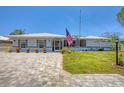 Charming single-story home boasts a manicured lawn and welcoming entrance at 619 Albee Farm N Rd, Nokomis, FL 34275