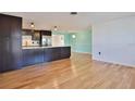 Modern kitchen and breakfast area with stainless steel appliances and wooden floors at 7355 Cass Cir, Sarasota, FL 34231