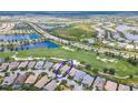 Aerial view of a home circled in blue, near a golf course, a lake, and a road at 7542 Windy Hill Cv, Bradenton, FL 34202