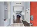 Inviting foyer with tile floors, coat hooks, and views of the open living area at 1126 Barclay Wood Dr, Ruskin, FL 33570