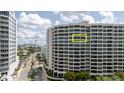 A condo exterior featuring a high-rise building with large windows and a sunny view at 1255 N Gulfstream Ave # 1104, Sarasota, FL 34236