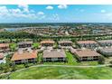 Aerial view of a residential neighborhood featuring multi-Gathering homes, lakes, and lush landscaping at 13609 Messina Loop # 104, Bradenton, FL 34211