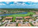 Aerial view of homes in a golf course community featuring a lake and lush landscaping at 13609 Messina Loop # 104, Bradenton, FL 34211