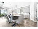 Open kitchen with gray cabinets, stainless steel appliances, white countertops, and a center island with seating at 13871 Heartwood Way, Parrish, FL 34219
