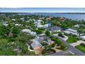 An aerial view showcases a waterfront community with beautiful homes, mature trees, and picturesque waterways at 1808 Coquina Dr, Sarasota, FL 34231