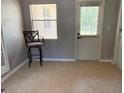 Bright interior room with tile flooring, a bar stool, and a door leading to the outside at 2311 W 52Nd Ave Drive, Bradenton, FL 34207