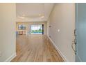 Bright living room with tile flooring, recessed lighting, and sliding glass doors leading to a pool at 2469 Paradise Plum Dr, Sarasota, FL 34240