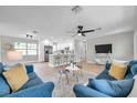 Spacious living area with an eat-in kitchen, breakfast bar seating, and stylish light fixtures at 3153 Irving St, Sarasota, FL 34237