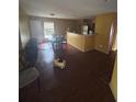 A glimpse of the living room reveals a dining area, access to the kitchen, and a bright window at 3622 N 51St St, Tampa, FL 33619
