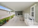 Open carport with access to a screened porch and the main entrance at 3818 Chris Dr, Wesley Chapel, FL 33543