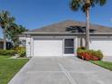 A single-story home showcasing a two-car garage and well-maintained driveway at 4153 Fairway Dr, North Port, FL 34287